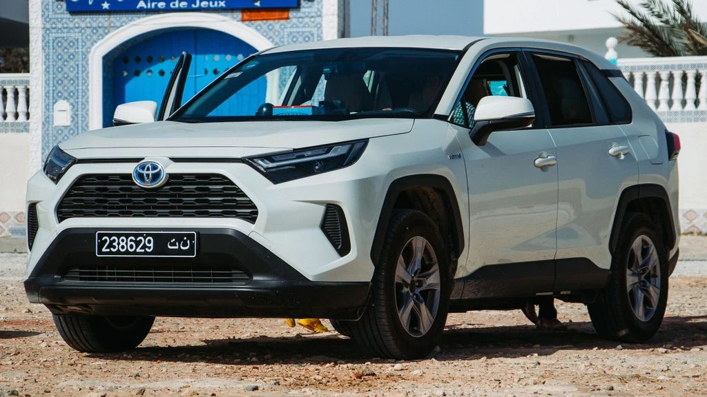 A gray 2019 Toyota RAV4 Hybrid XLE parked beside a Wisconsin lake.